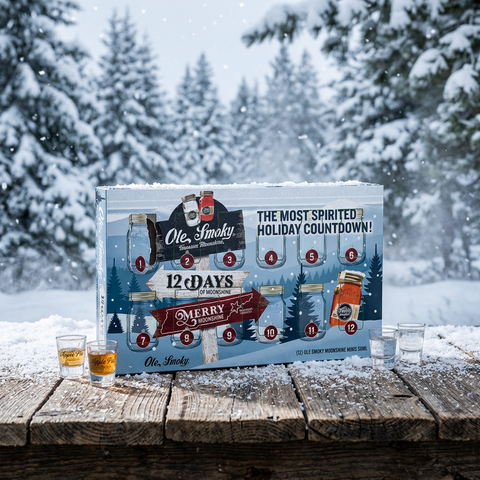 Ole Smoky 12 Days of Moonshine advent calendar in the snow with moonshine shot glasses
